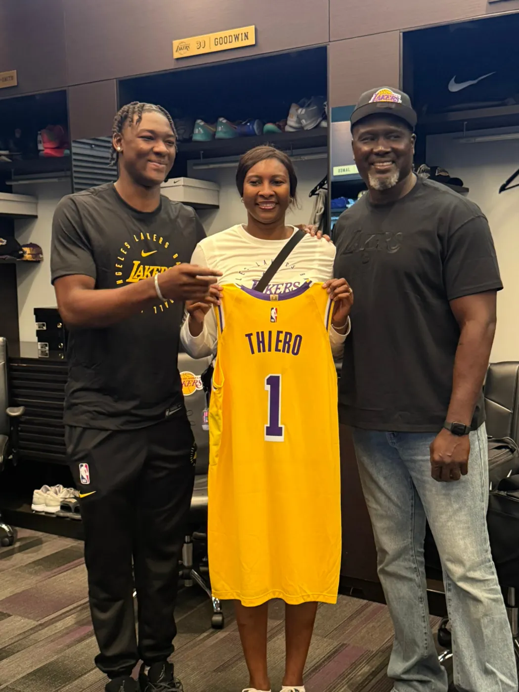 Professional athlete and family with a personalized jersey in the locker room