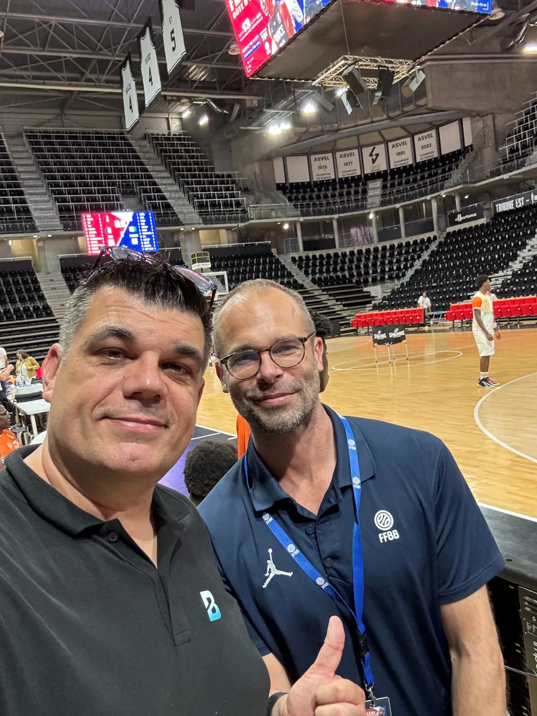 Jean Pierre Ciesielski courtside with a member of the sports federation staff