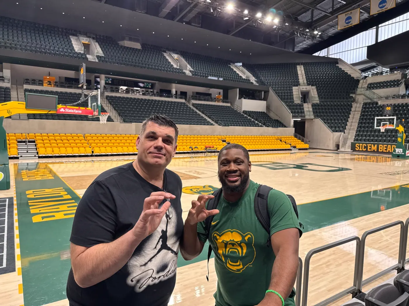 Jean Pierre Ciesielski with a staff member on a US college basketball court